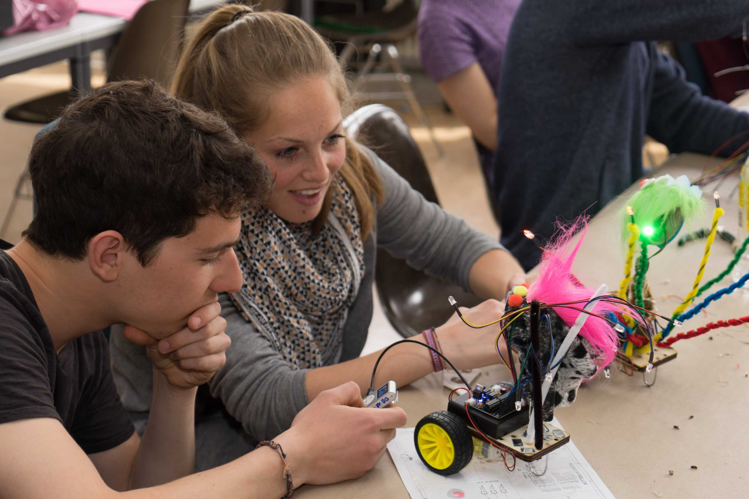 Two students working on a dancing robot