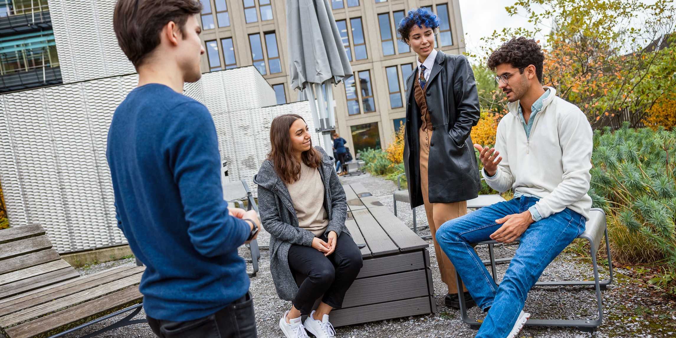 Male and female students chatting on the roof top garden of the LEE building
